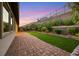 Landscaped backyard with artificial turf and retaining wall at 349 Agnew St, Las Vegas, NV 89138