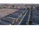 Aerial view of a residential neighborhood showcasing well-maintained homes and streets at dusk at 3540 Valley Lily St, North Las Vegas, NV 89032