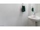 Powder room features a pedestal sink and modern fixtures at 3540 Valley Lily St, North Las Vegas, NV 89032