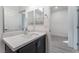 Bathroom featuring a dark vanity with white countertop, undermount sink, and modern fixtures at 3540 Valley Lily St, North Las Vegas, NV 89032