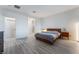 Bright bedroom featuring wood-look floors, a modern platform bed, and minimalist decor at 3540 Valley Lily St, North Las Vegas, NV 89032