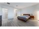 Bright bedroom with modern wood floors, and a cozy bed setup, bathed in natural light at 3540 Valley Lily St, North Las Vegas, NV 89032