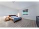 Contemporary bedroom with wood-look floors, a stylish bed, and simple furnishings at 3540 Valley Lily St, North Las Vegas, NV 89032