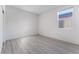 Bright bedroom featuring gray wood flooring and a window at 3540 Valley Lily St, North Las Vegas, NV 89032