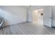 Light-filled room with double doors leading to a glimpse of the kitchen; wood-look flooring at 3540 Valley Lily St, North Las Vegas, NV 89032