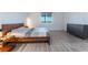 Minimalist bedroom featuring wood-look flooring, a modern bed frame, and a dresser at 3540 Valley Lily St, North Las Vegas, NV 89032