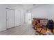 Bedroom with wood-look floors, white doors, and fresh white paint at 3540 Valley Lily St, North Las Vegas, NV 89032