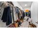 Walk-in closet packed with clothing and storage containers on shelves and hanging racks at 3540 Valley Lily St, North Las Vegas, NV 89032
