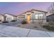 A single-story home featuring a stone facade, desert landscaping, and a two car garage at 3540 Valley Lily St, North Las Vegas, NV 89032