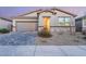 Inviting home with a two-car garage, stone accents, and low-maintenance front yard at 3540 Valley Lily St, North Las Vegas, NV 89032