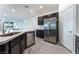 Modern kitchen with a stainless steel dishwasher and refrigerator with dark wood cabinets at 3540 Valley Lily St, North Las Vegas, NV 89032