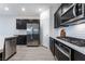 Modern kitchen featuring stainless steel appliances, dark cabinetry, and a white subway tile backsplash at 3540 Valley Lily St, North Las Vegas, NV 89032