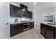 Stylish kitchen with stainless steel appliances, dark cabinetry, and modern tile backsplash at 3540 Valley Lily St, North Las Vegas, NV 89032