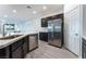 Bright kitchen with stainless steel appliances, dark cabinets, white countertop, and wood-look flooring at 3540 Valley Lily St, North Las Vegas, NV 89032