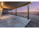 A covered patio features sleek concrete flooring, columns, and a view of the backyard space at 3540 Valley Lily St, North Las Vegas, NV 89032