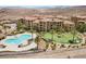 Community aerial view showcasing the building's swimming pool and turfed recreational area, with landscaping at 4 Via Centrale # 1, Henderson, NV 89011