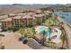 Aerial view of the property showcasing the pool, turf, and community layout with palm trees at 4 Via Centrale # 1, Henderson, NV 89011