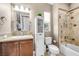 Cozy bathroom with a bathtub, granite counter, and white cabinet at 4 Via Centrale # 1, Henderson, NV 89011