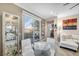 Bright dining area with glass table, white chairs, and patio access at 4 Via Centrale # 1, Henderson, NV 89011