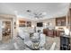 Open concept dining area with glass table and white chairs at 4 Via Centrale # 1, Henderson, NV 89011