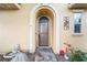 Inviting front entrance with arched doorway, decorative details, and stone walkway at 4 Via Centrale # 1, Henderson, NV 89011