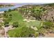 Elevated aerial view showcasing a lush golf course surrounded by green trees and serene water features at 4 Via Centrale # 1, Henderson, NV 89011