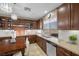 Spacious kitchen with dark wood cabinets and granite countertops at 4 Via Centrale # 1, Henderson, NV 89011