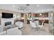 Bright living room featuring a fireplace, kitchen, dining area, and travertine floors at 4 Via Centrale # 1, Henderson, NV 89011