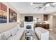 Bright living room with white couches, fireplace, and large TV at 4 Via Centrale # 1, Henderson, NV 89011