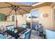 Relax on the patio with an umbrella, stylish furniture, and fountain at 4 Via Centrale # 1, Henderson, NV 89011