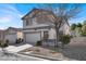 Two-story house with attached garage and tree in front yard at 4439 Yellow Harbor St, Las Vegas, NV 89129