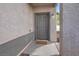 Gray front door with a small mat, located on a light-colored walkway at 4439 Yellow Harbor St, Las Vegas, NV 89129