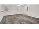 Living room with gray vinyl plank flooring, and neutral-colored walls at 4439 Yellow Harbor St, Las Vegas, NV 89129