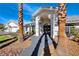 Front entrance with arched entryway and mature palm trees at 4620 Clay Peak Dr, Las Vegas, NV 89129