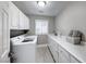 Bright laundry room with washer, dryer, and white cabinets at 4620 Clay Peak Dr, Las Vegas, NV 89129