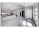 Spacious living room with light gray tile floors and a fireplace at 4620 Clay Peak Dr, Las Vegas, NV 89129