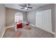 Home office with glass desk, red chairs, and a ceiling fan at 4620 Clay Peak Dr, Las Vegas, NV 89129