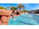 Resort style pool with rock waterfall and lush landscaping at 4620 Clay Peak Dr, Las Vegas, NV 89129