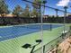 View of the community tennis court featuring a chain-link fence and a two-tone blue and green court at 4620 Clay Peak Dr, Las Vegas, NV 89129