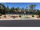 Community tennis court with well-maintained green and blue court surface and surrounding landscaping at 4620 Clay Peak Dr, Las Vegas, NV 89129