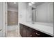 Bathroom boasts dark vanity, white countertop, and tiled shower/tub at 4807 Enchanted View St, Las Vegas, NV 89149