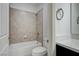 Neat bathroom with tiled walls and a bathtub at 4807 Enchanted View St, Las Vegas, NV 89149