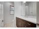 Modern bathroom with dark vanity, white countertop, and tiled floor at 4807 Enchanted View St, Las Vegas, NV 89149