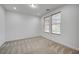 Well-lit bedroom with neutral carpeting and large windows at 4807 Enchanted View St, Las Vegas, NV 89149