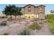 Two-story house with landscaped yard, stone pathway, and two-car garage at 4807 Enchanted View St, Las Vegas, NV 89149