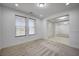 Bright and airy living room with neutral decor and carpeting at 4807 Enchanted View St, Las Vegas, NV 89149