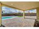 Covered patio overlooking the pool and backyard at 4807 Enchanted View St, Las Vegas, NV 89149