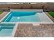 Relaxing pool and spa with brick patio and sun shelf at 4807 Enchanted View St, Las Vegas, NV 89149