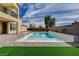 Inviting pool and spa with brick patio and grassy area at 4807 Enchanted View St, Las Vegas, NV 89149