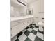 Clean bathroom, featuring a double vanity and checkered floor at 4917 E Washington Ave, Las Vegas, NV 89110